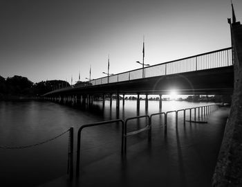 Bridge over river at sunset