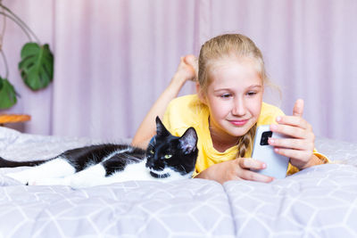 Portrait of cute girl playing with toy on bed at home