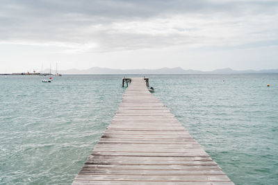 Beach of alcudia in spain with a pier
