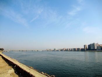 Scenic view of sea and buildings against sky