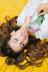 Top view young woman on a picnic, lying on a blanket. she is happy and smiles a dazzling 