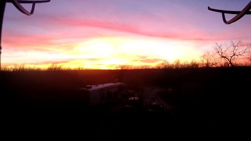 Scenic view of landscape against sky at sunset