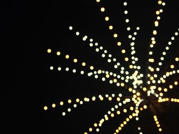 Low angle view of illuminated lights at night