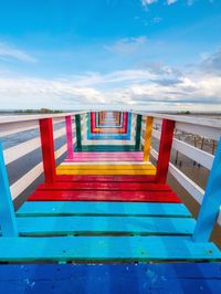 View of empty bridge over sea against sky. rainbow bridge and seaside bridge, bright colors.