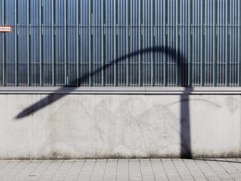 Shadow of lamppost against wall