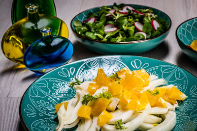 High angle view of orange and fennel in plate on table