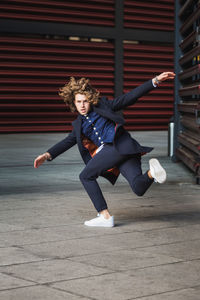 Full length portrait of man dancing outdoors