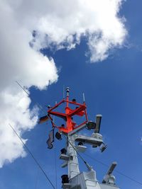 Low angle view of lifeboat mast against sky