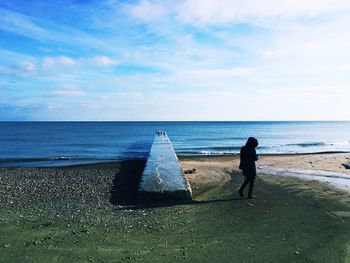 Man on beach against sky