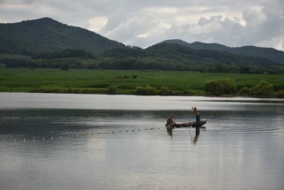 Scenic view of lake and mountains against sky