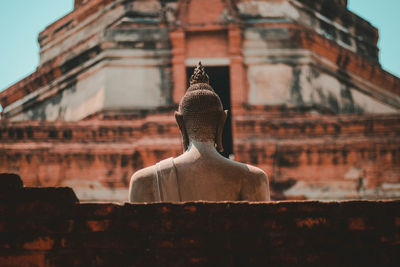 Statue outside temple against building