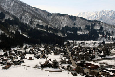 High angle view of townscape and mountains during winter