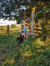 Woman with dog standing in park