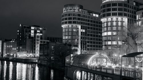 Reflection of illuminated buildings in city at night