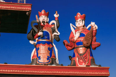 Low angle view of statue against clear blue sky