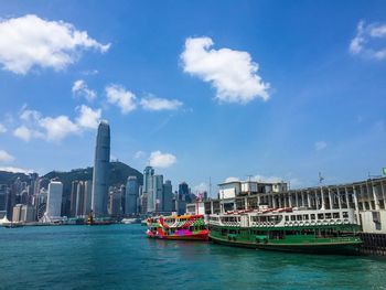 View of buildings in sea against cloudy sky