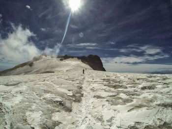 Scenic view of desert against sky on sunny day
