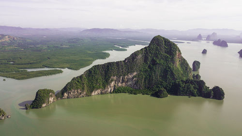 Scenic view of sea and mountains against sky