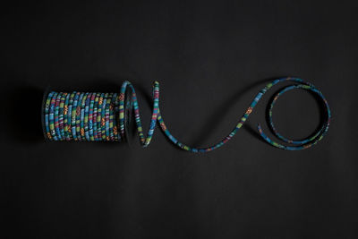 Close-up of multi colored pencils over black background