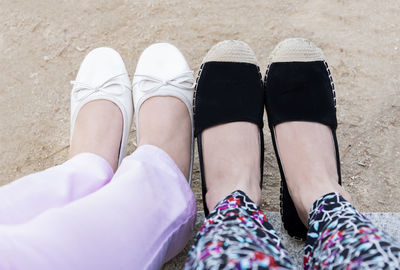 Low section of women sitting outdoors