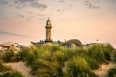 Lighthouse against sky during sunset