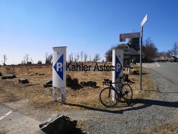 Road sign against clear blue sky