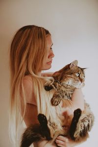 Midsection of woman holding cat