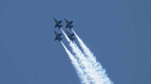 Low angle view of airplane flying against sky