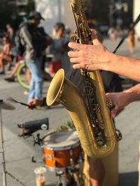 Midsection of man playing music on street in city