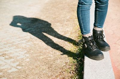 Low section of man standing on tiled floor