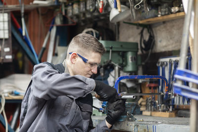 Plumber male working in a workshop