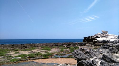 Scenic view of sea against clear blue sky