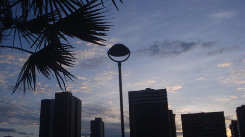 Low angle view of silhouette buildings against sky