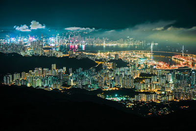 Illuminated cityscape against sky at night