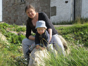 Portrait of mother and daughter on grassy field