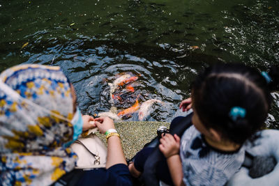 High angle view of people swimming in lake