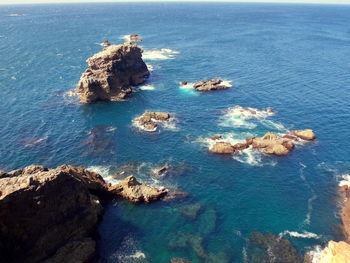 High angle view of rocks in sea