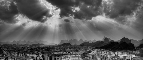 Panoramic view of mountains against cloudy sky