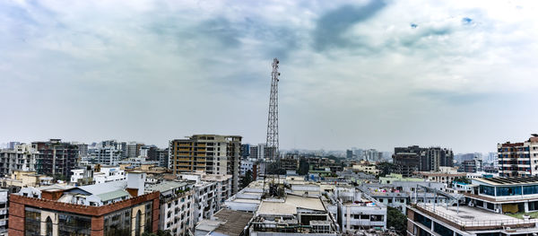 High angle view of buildings against cloudy sky