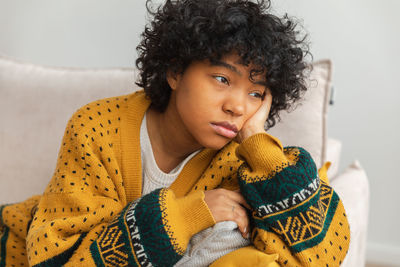 Portrait of smiling young woman sitting at home