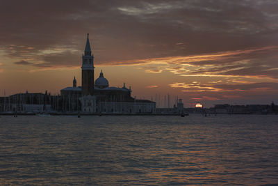 San giorgio maggiore by grand canal against cloudy sky during sunset