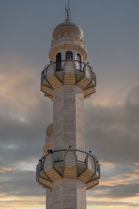 Low angle view of lighthouse against sky during sunset