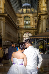 Rear view of couple holding hands