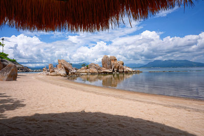 View of beach against cloudy sky