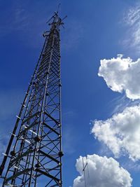 Low angle view of communications tower against blue sky