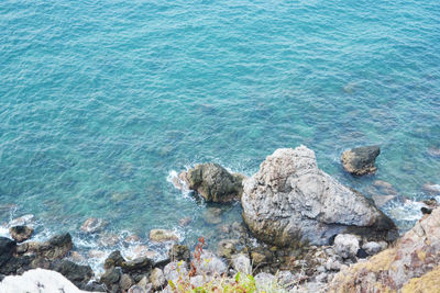 High angle view of rocks at sea shore