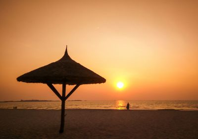 Scenic view of sea against orange sky