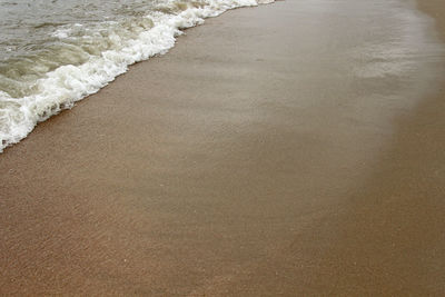 High angle view of waves rushing towards shore