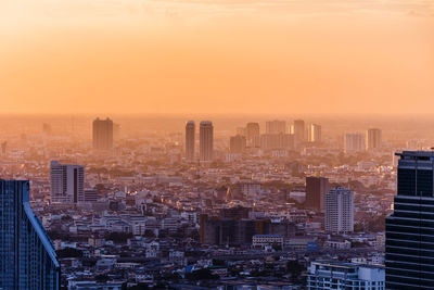 Aerial view of cityscape against sky during sunset