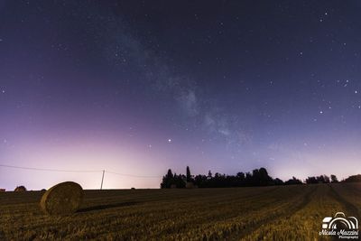 Scenic view of field against sky at night